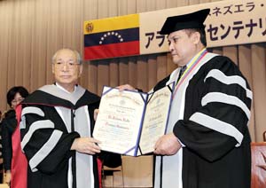 瓜里斯马校长（右）与池田会长（左）手持荣誉称号证书